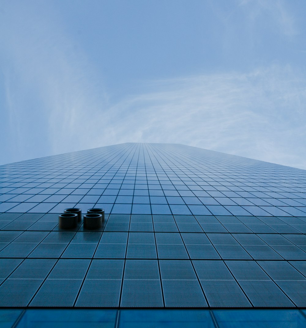 a pair of shoes sitting on the ground in front of a tall building