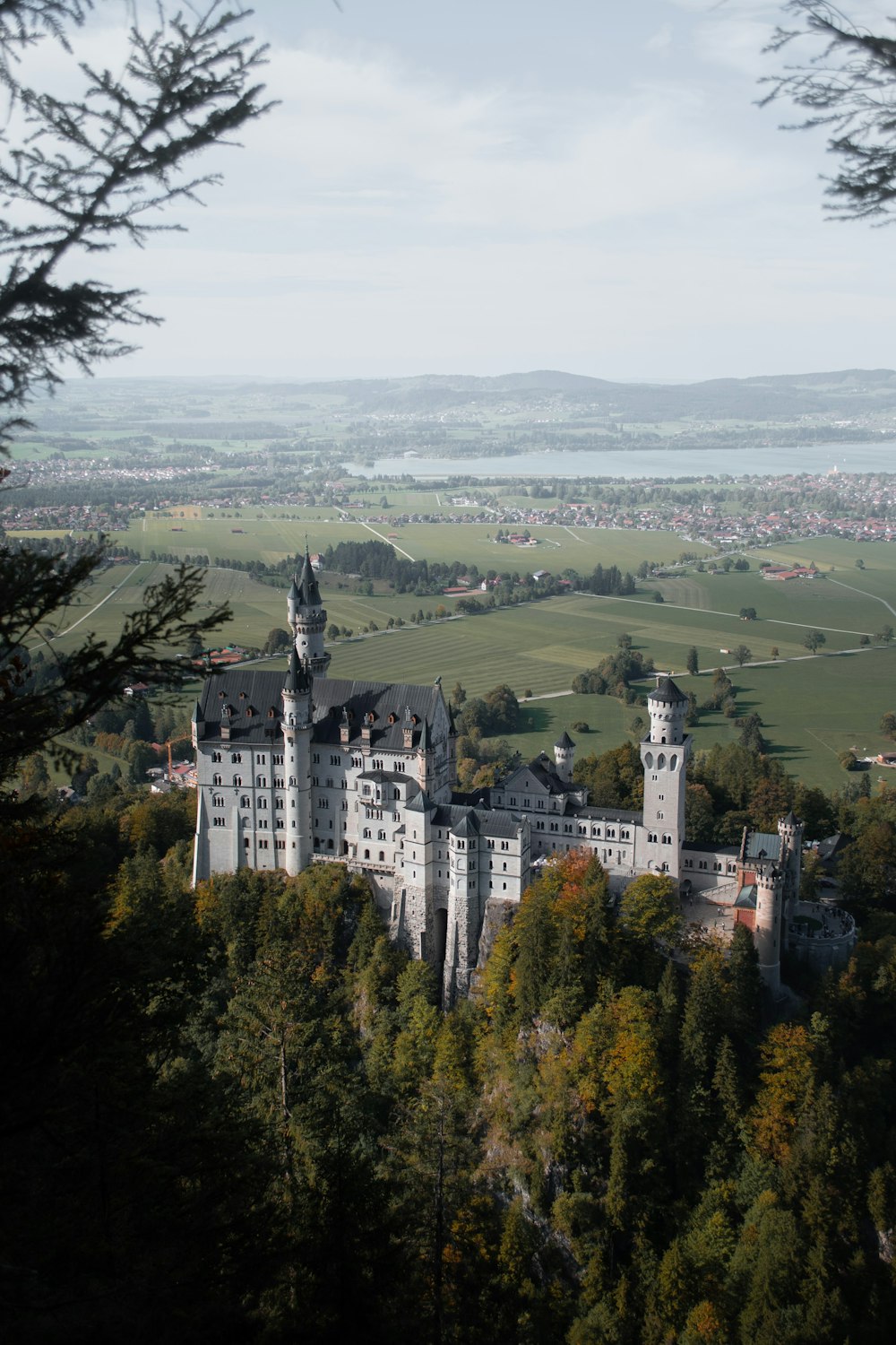 a castle on top of a hill surrounded by trees