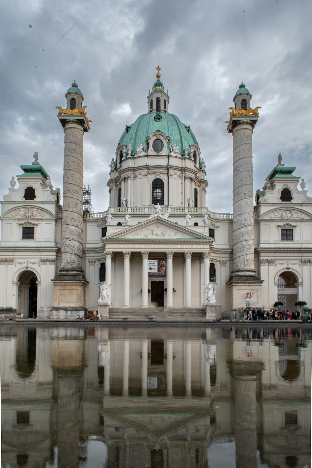 a large white building with a green dome