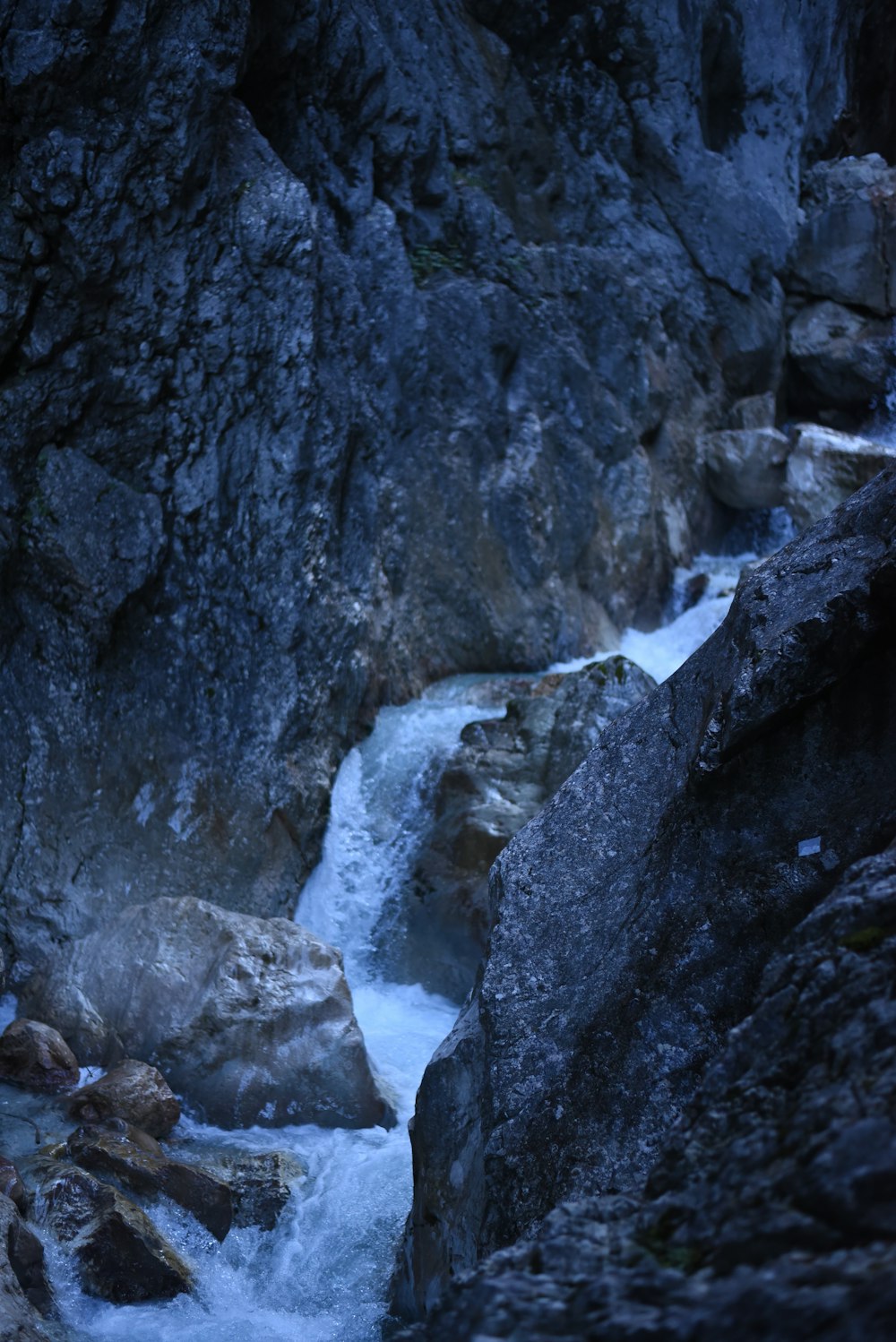 a man standing on top of a rock next to a river