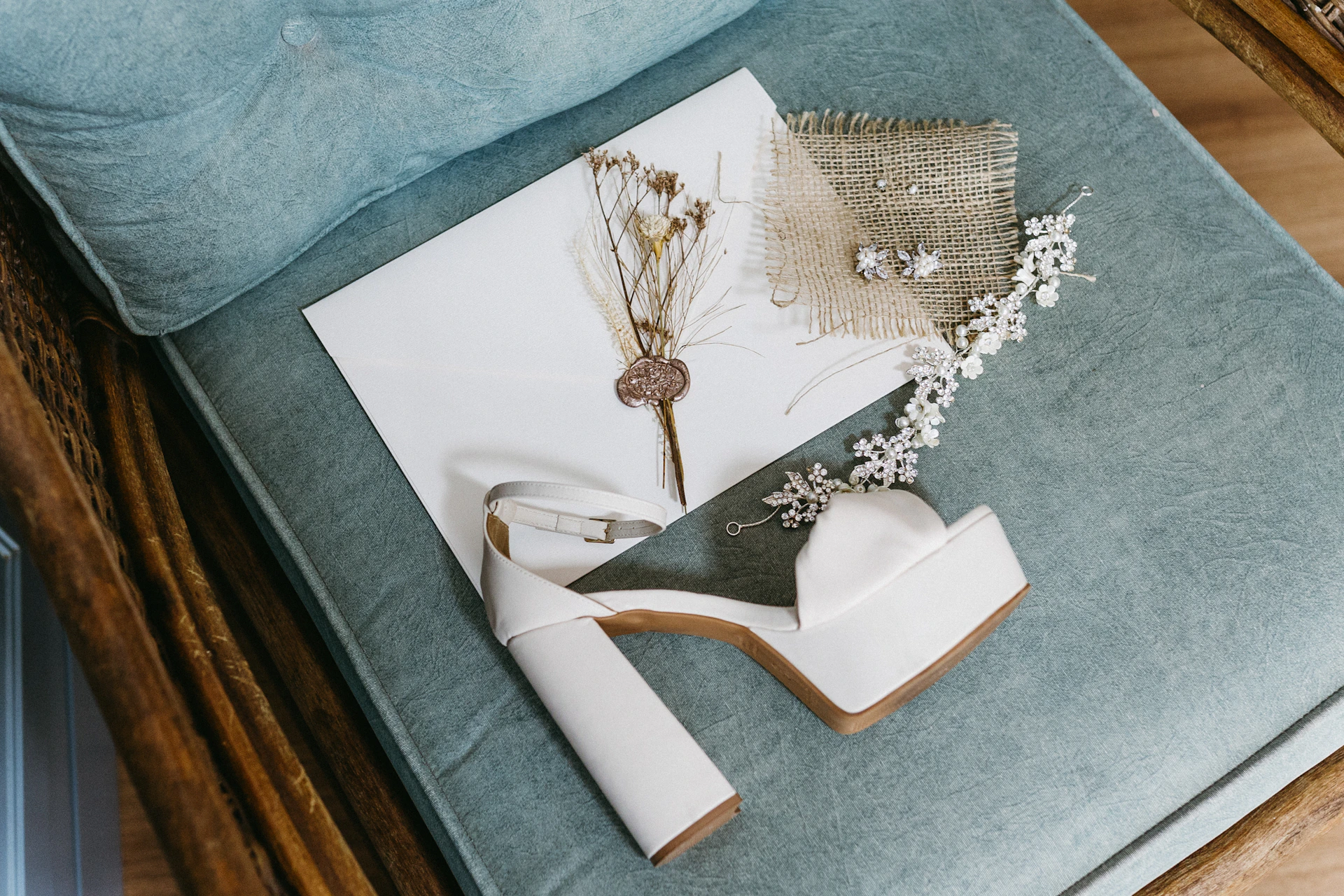 a pair of high heeled shoes sitting on top of a bed