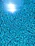 Close-up of a smooth, blue marble pool surface reflecting sunlight.