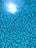 A sparkling blue swimming pool with a smooth, shiny surface under the sun.