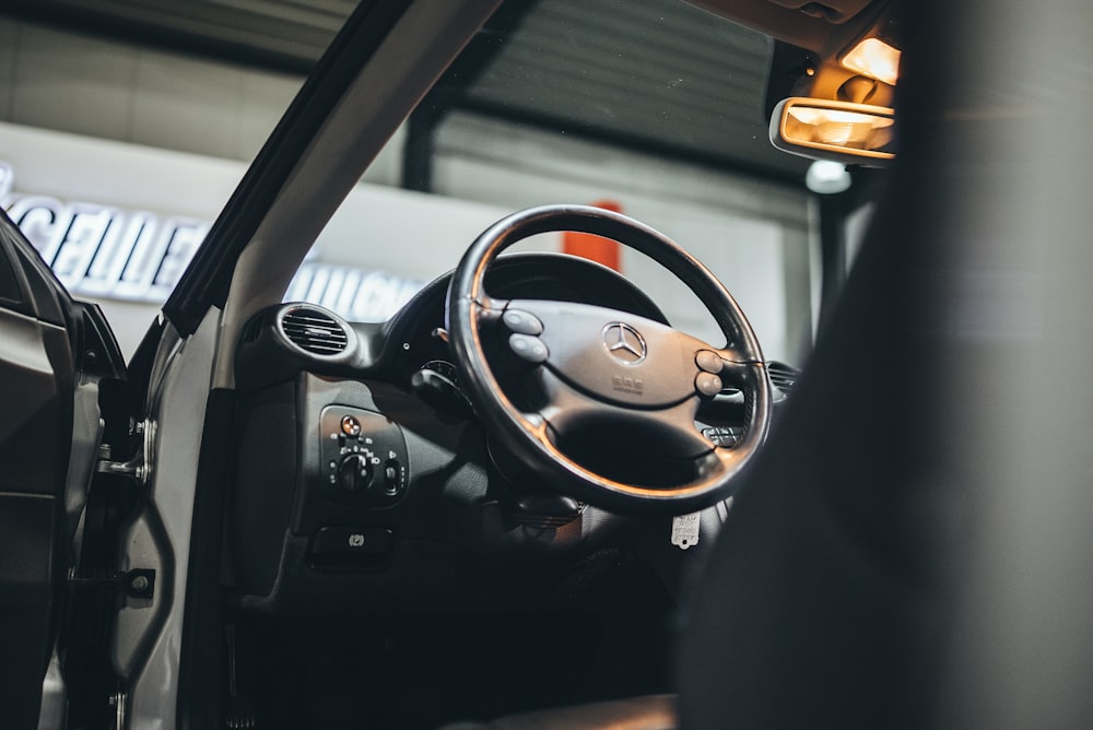 the interior of a vehicle with a steering wheel and dashboard