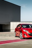 a red car parked in front of a building