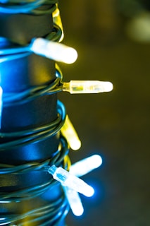 A close-up of colorful LED strip lights installed under kitchen cabinets.