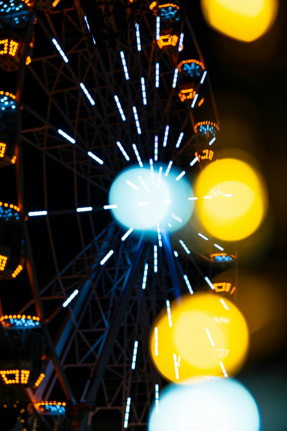 a ferris wheel lit up at night time