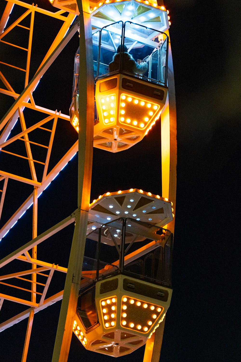 a ferris wheel lit up at night with lights