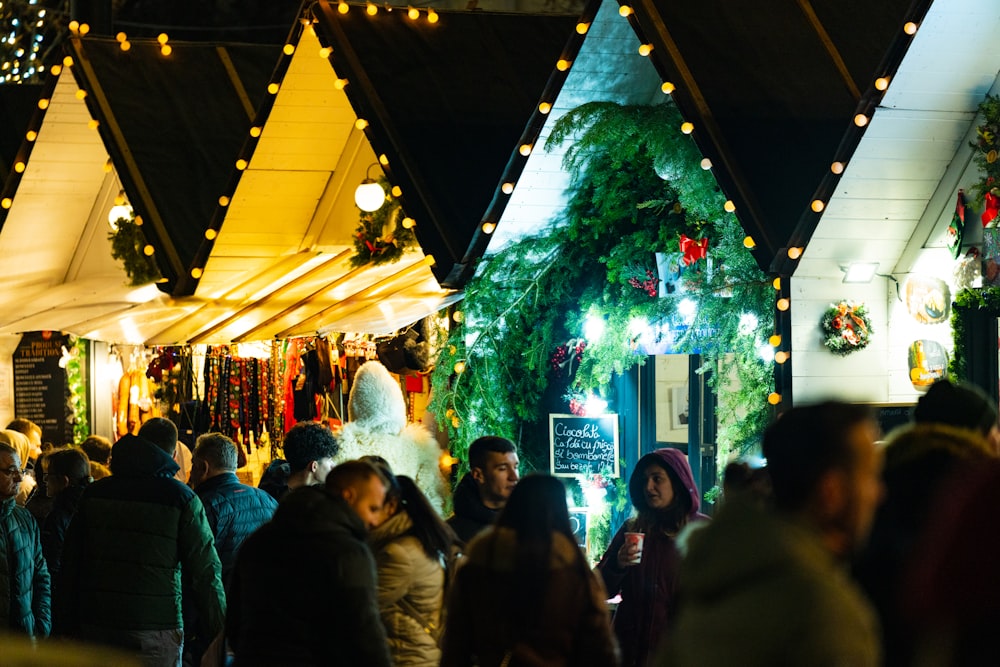 a crowd of people standing around a christmas market