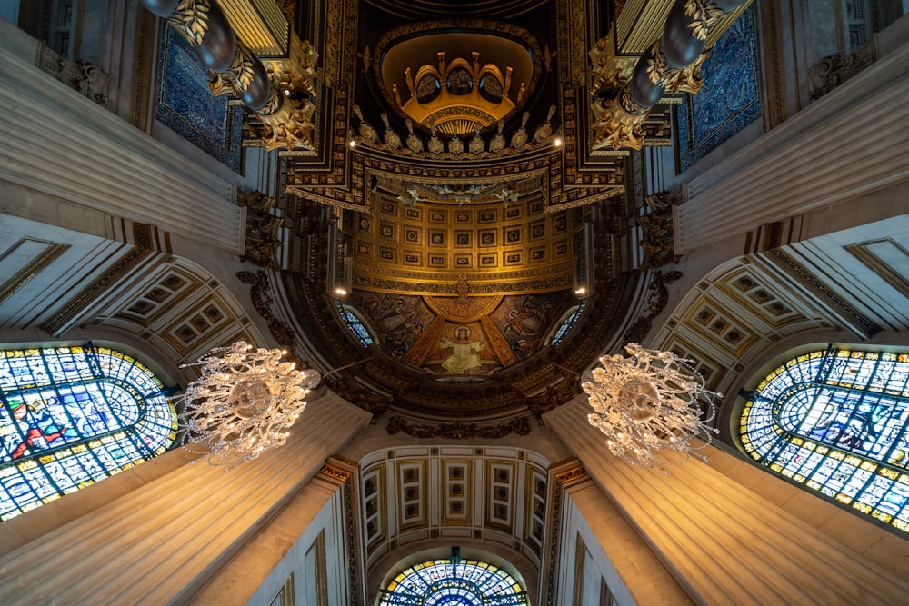 the ceiling of a church with stained glass windows