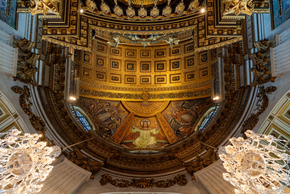 the ceiling of a large building with ornate decorations