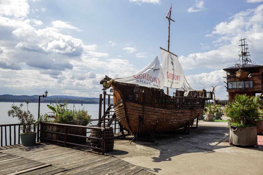 a boat sitting on top of a wooden pier