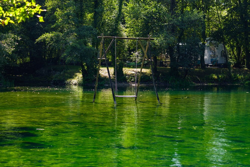 a swing in the middle of a body of water