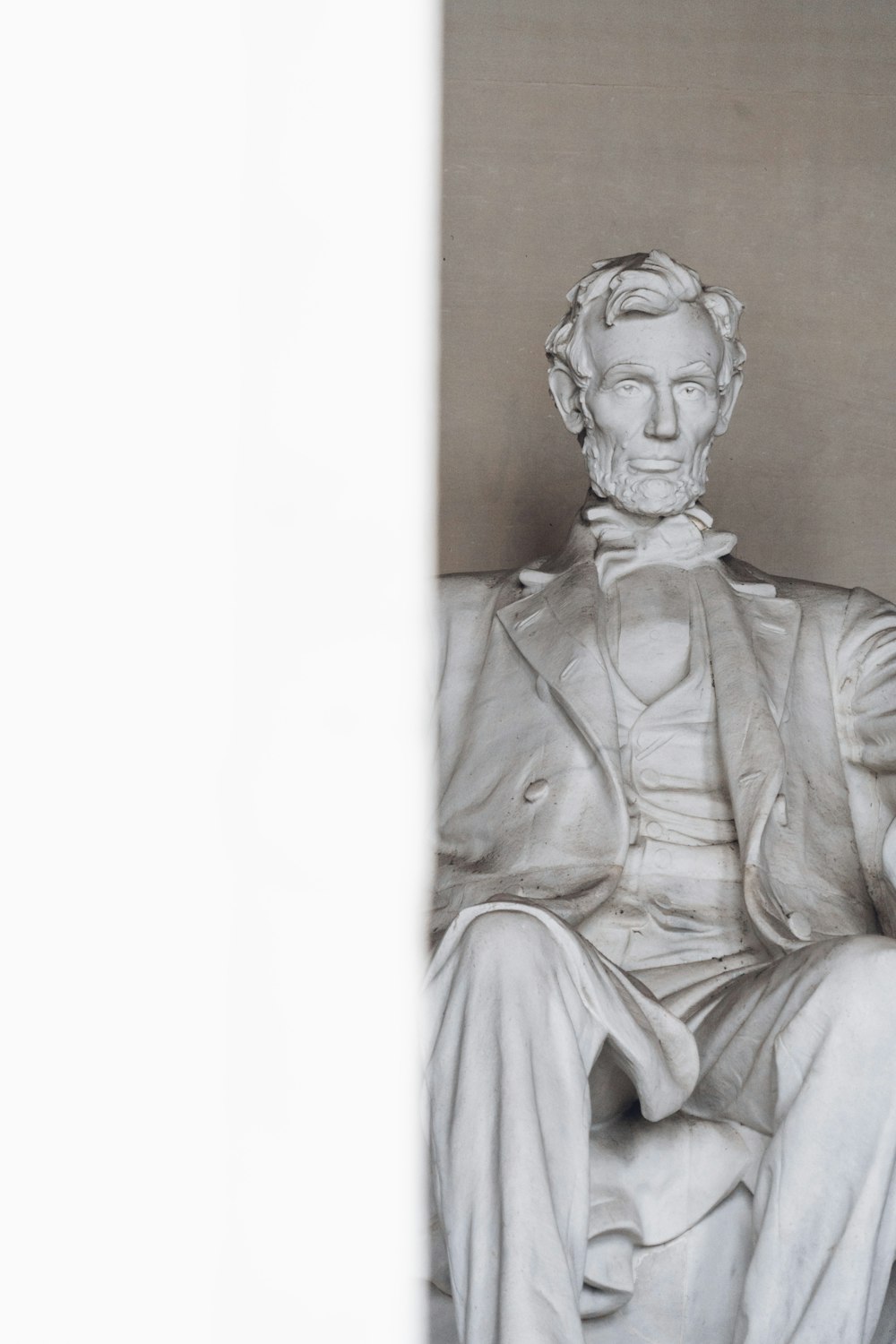 a statue of abraham lincoln sitting in a chair