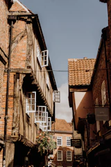 Charming historic street in Troyes with timber-framed houses bathed in warm sunlight.