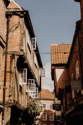 Charming historic street in Troyes with timber-framed houses bathed in warm sunlight.