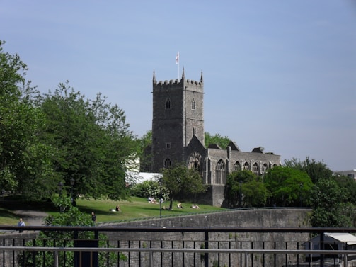 A warm, sunlit gathering of parishioners outside a historic Chesapeake Bay church.