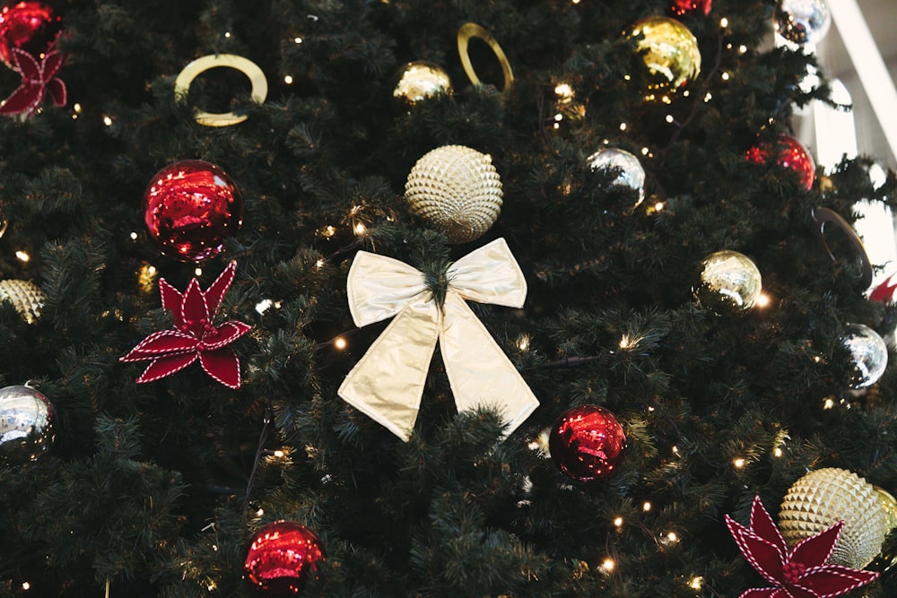 a decorated christmas tree with a white bow