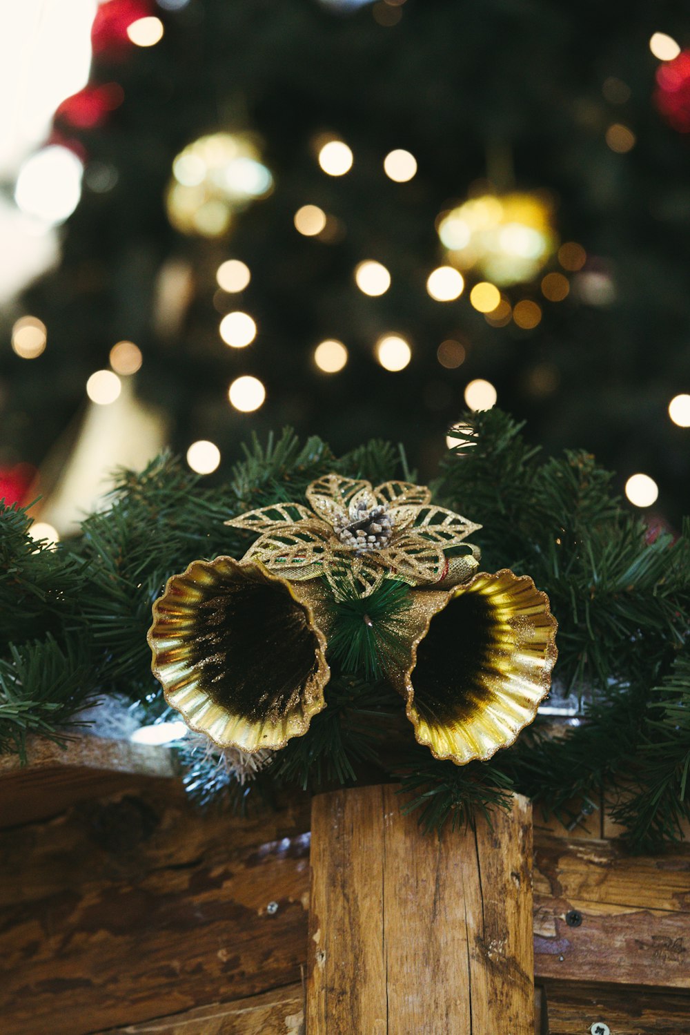 a close up of a wooden box with a christmas tree in the background