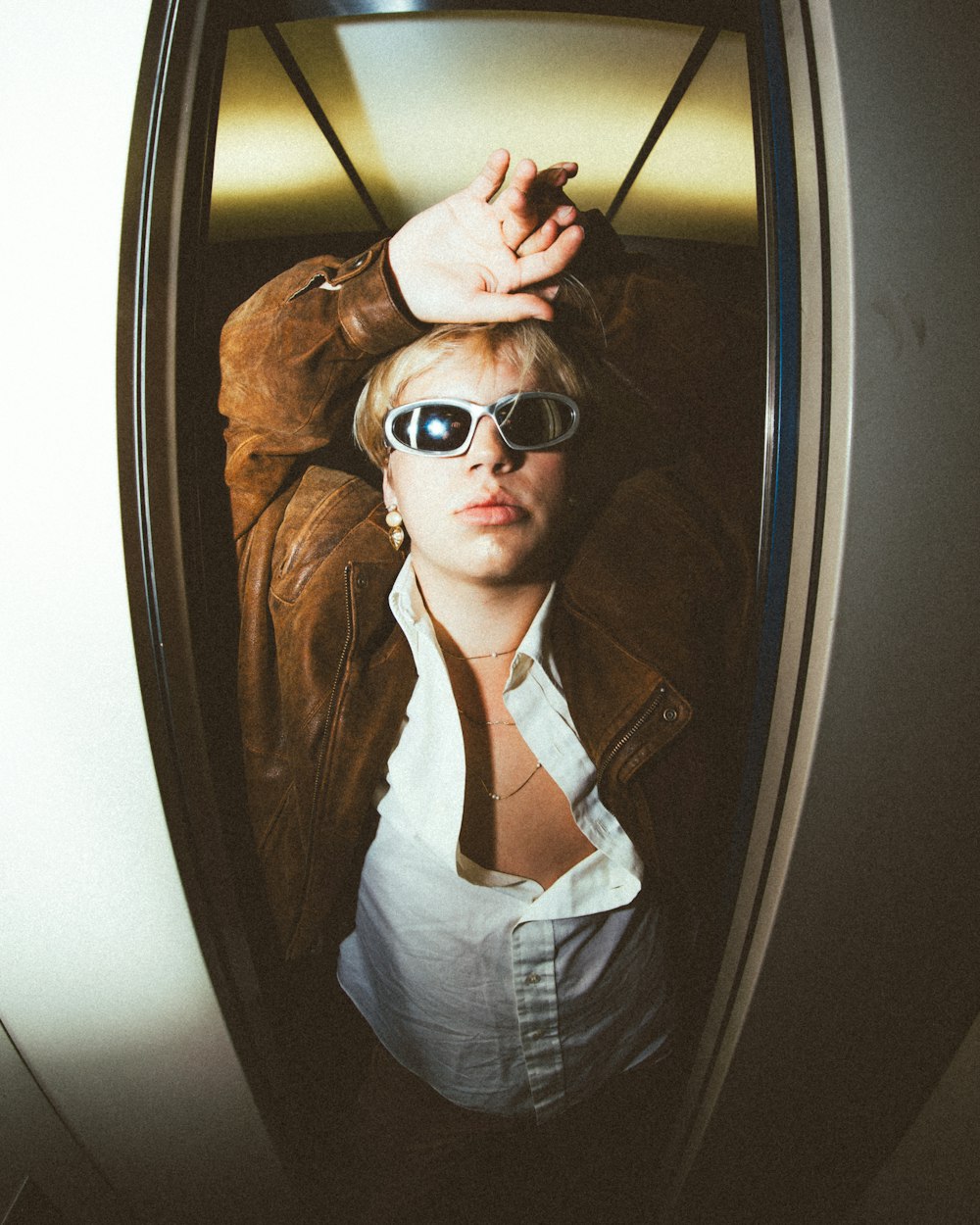 a woman wearing sunglasses and a leather jacket