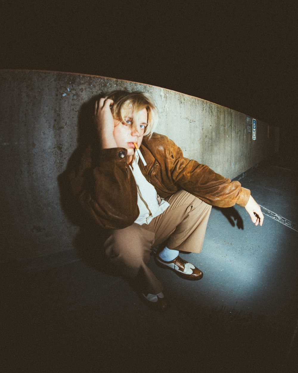 a man sitting on a skateboard in a skate park