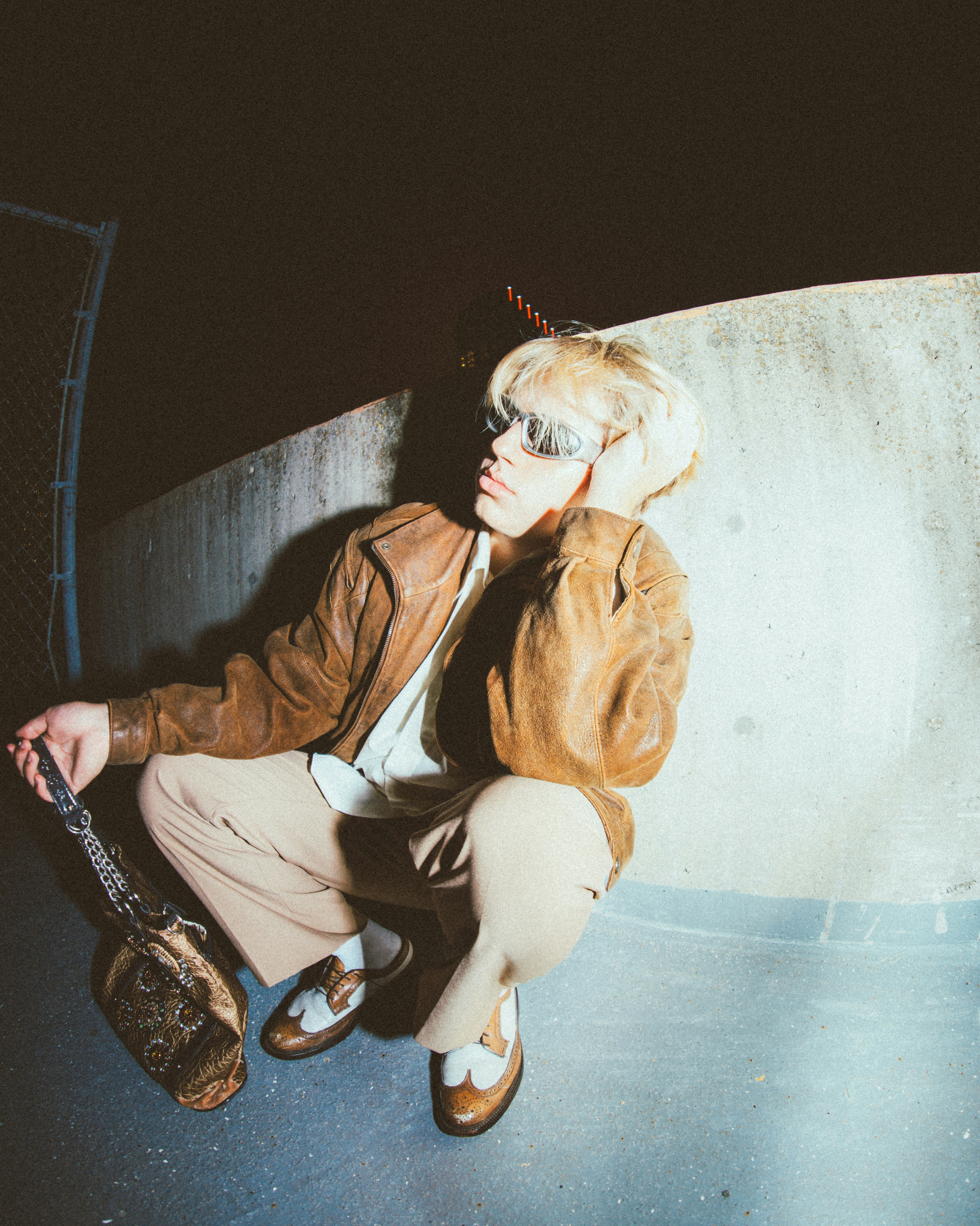 a person sitting on a skateboard in a skate park