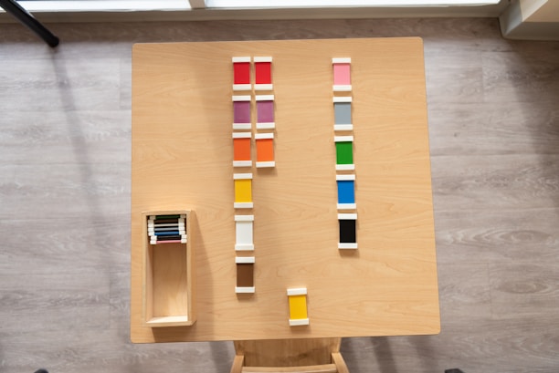 A close-up shot of various colorful tile samples arranged neatly on a wooden table.
