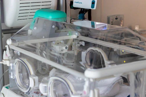 Neonatal care unit with advanced incubators and attentive medical staff.