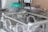 A neonatal incubator with a transparent enclosure, equipped with medical apparatus and monitoring devices. The incubator is designed to provide a controlled environment for newborns requiring medical care.