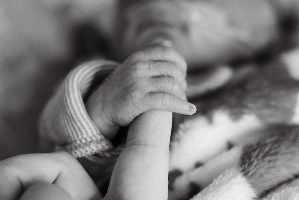 a close up of a person holding a baby