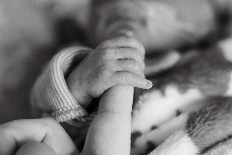 Parent holding a newborn skin to skin