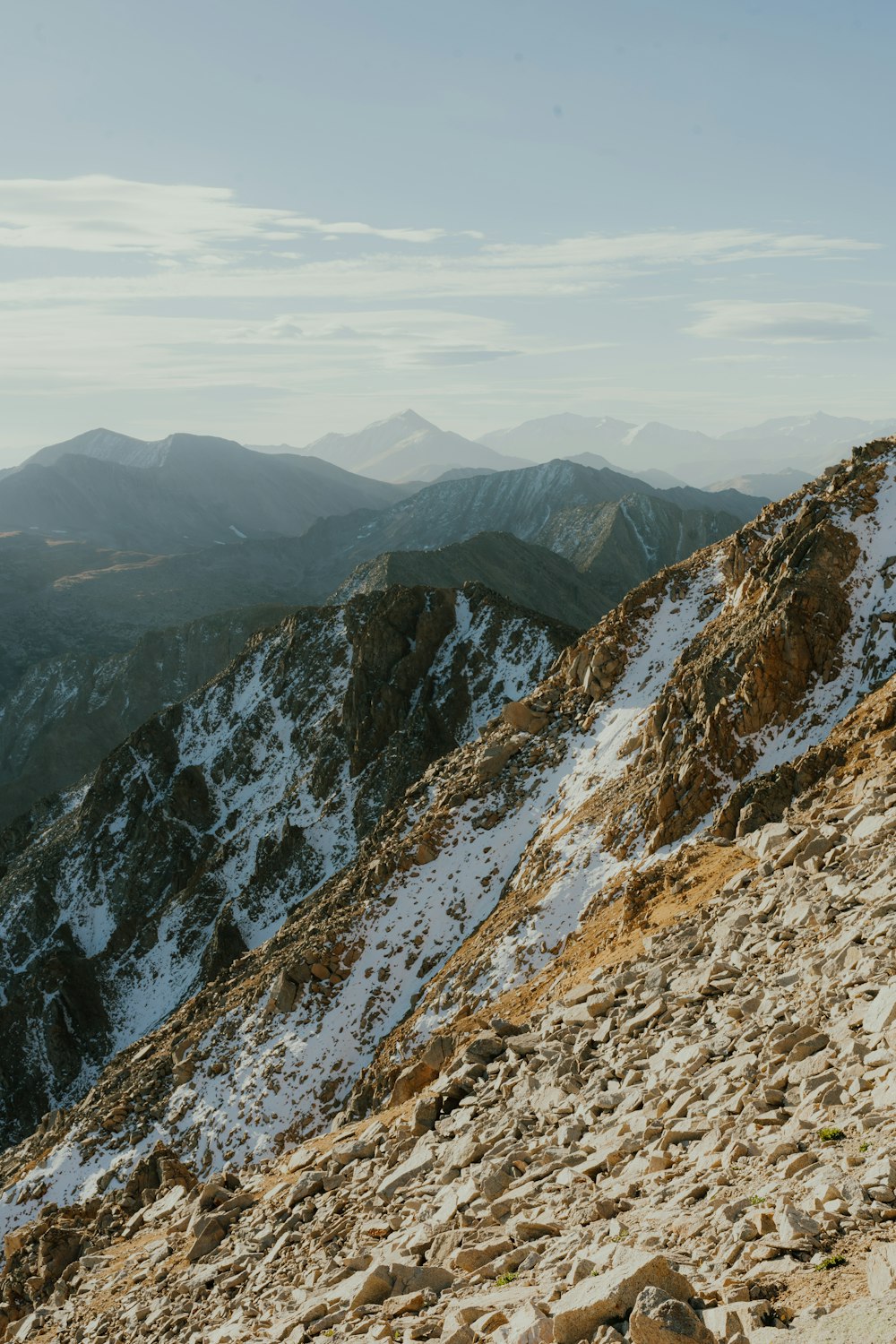 a man standing on top of a snow covered mountain