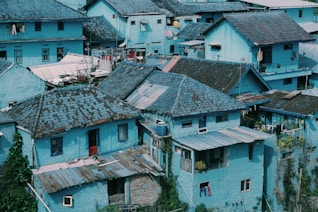 a group of blue buildings with a sky background