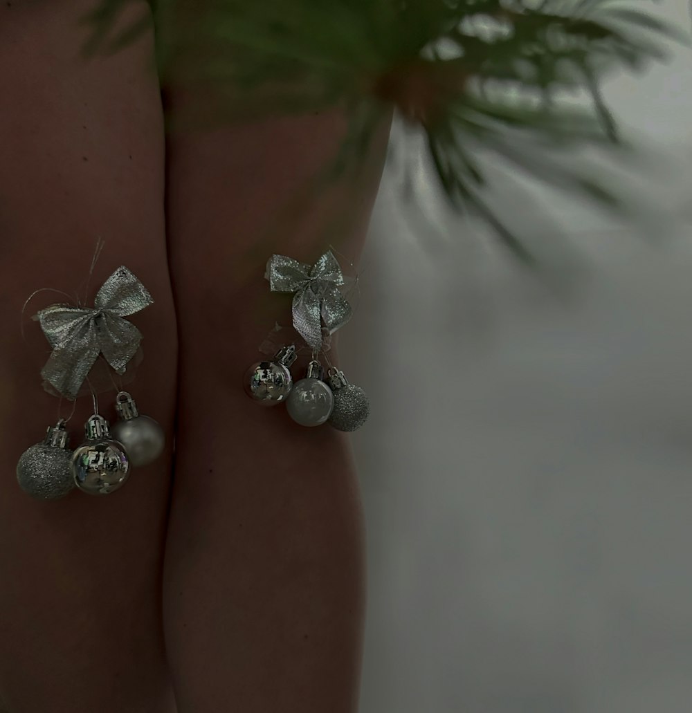 a close up of a pair of silver bells