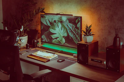 Soft-focus image of a calm workspace featuring a sage accent plant beside a clean keyboard.