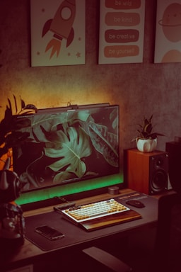 A cozy office desk with a computer, phone, and a small plant, inviting contact.