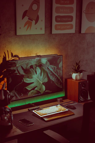 A cozy home office setup with calming green plants and a laptop displaying a wellness app.