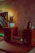 A happy customer enjoying music with Sonicara speakers glowing softly in a cozy living room.