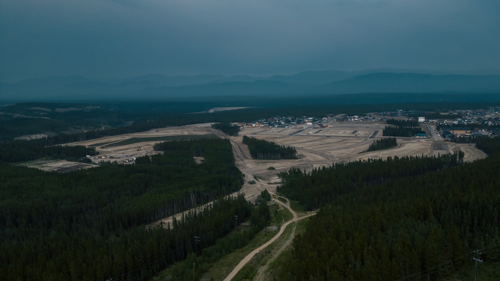 an aerial view of a construction site in the middle of a forest