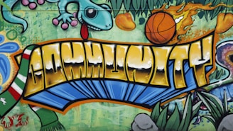 a graffiti wall with a dragon and a basketball on it