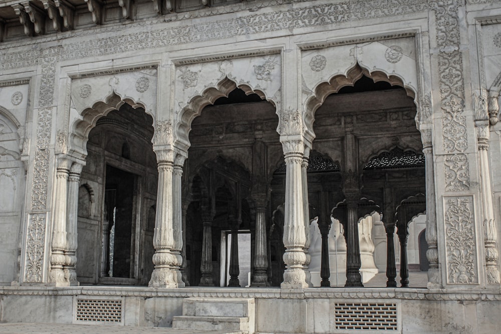 a large white building with pillars and arches