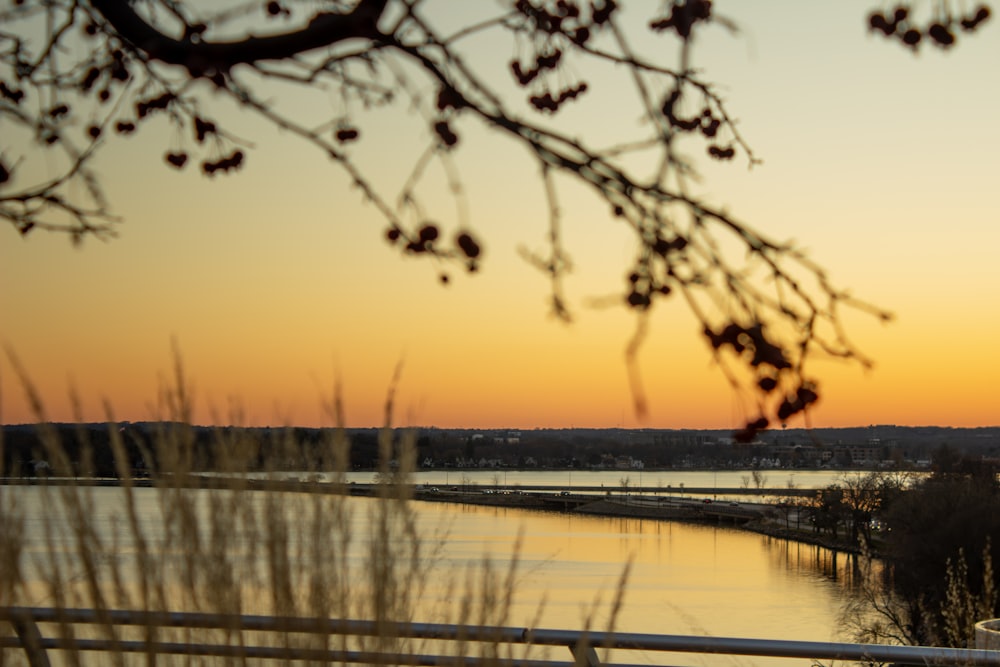 the sun is setting over a body of water