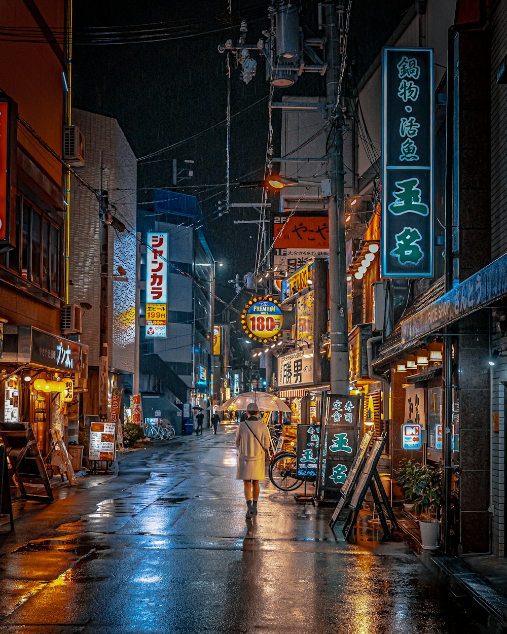 a person walking down a street in the rain