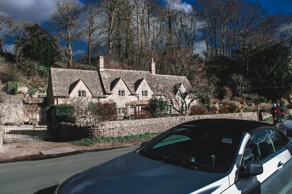 a car parked in front of a stone house