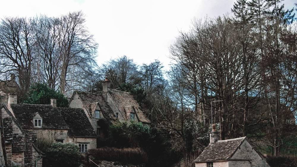 an old stone house with trees in the background