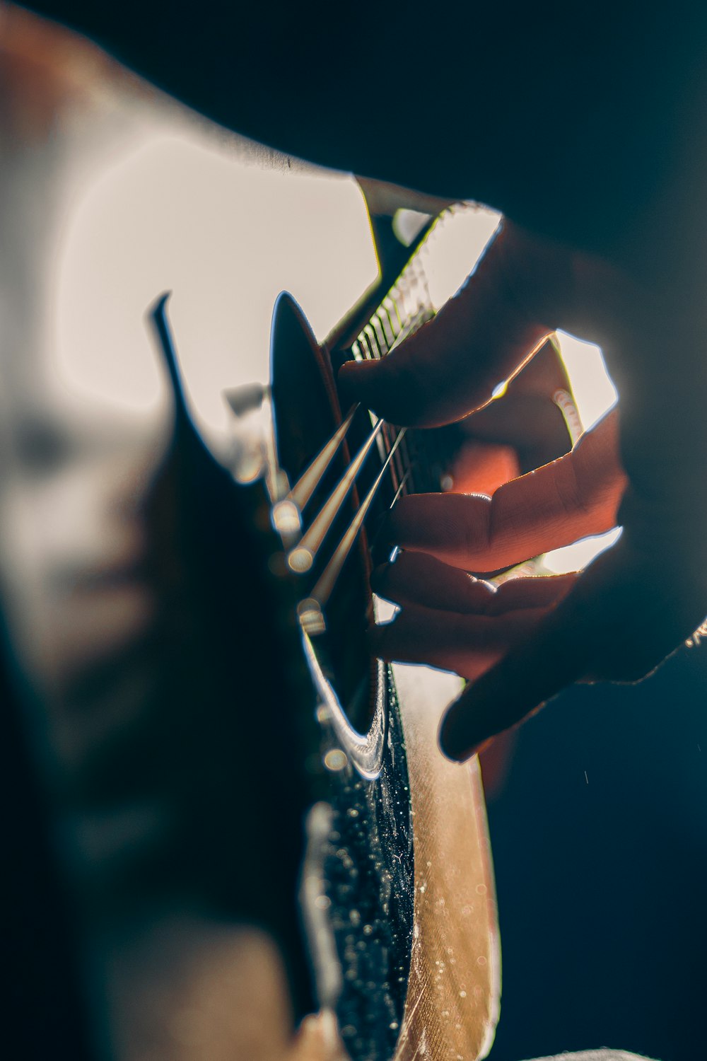 a person playing a guitar with their hands