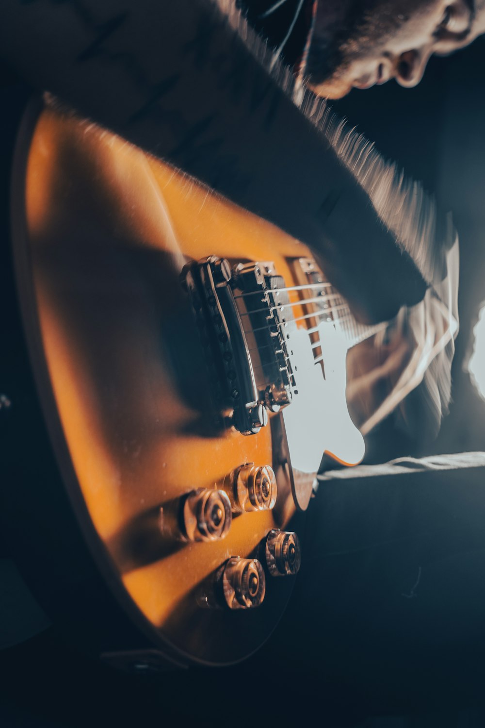 a close up of a person playing a guitar