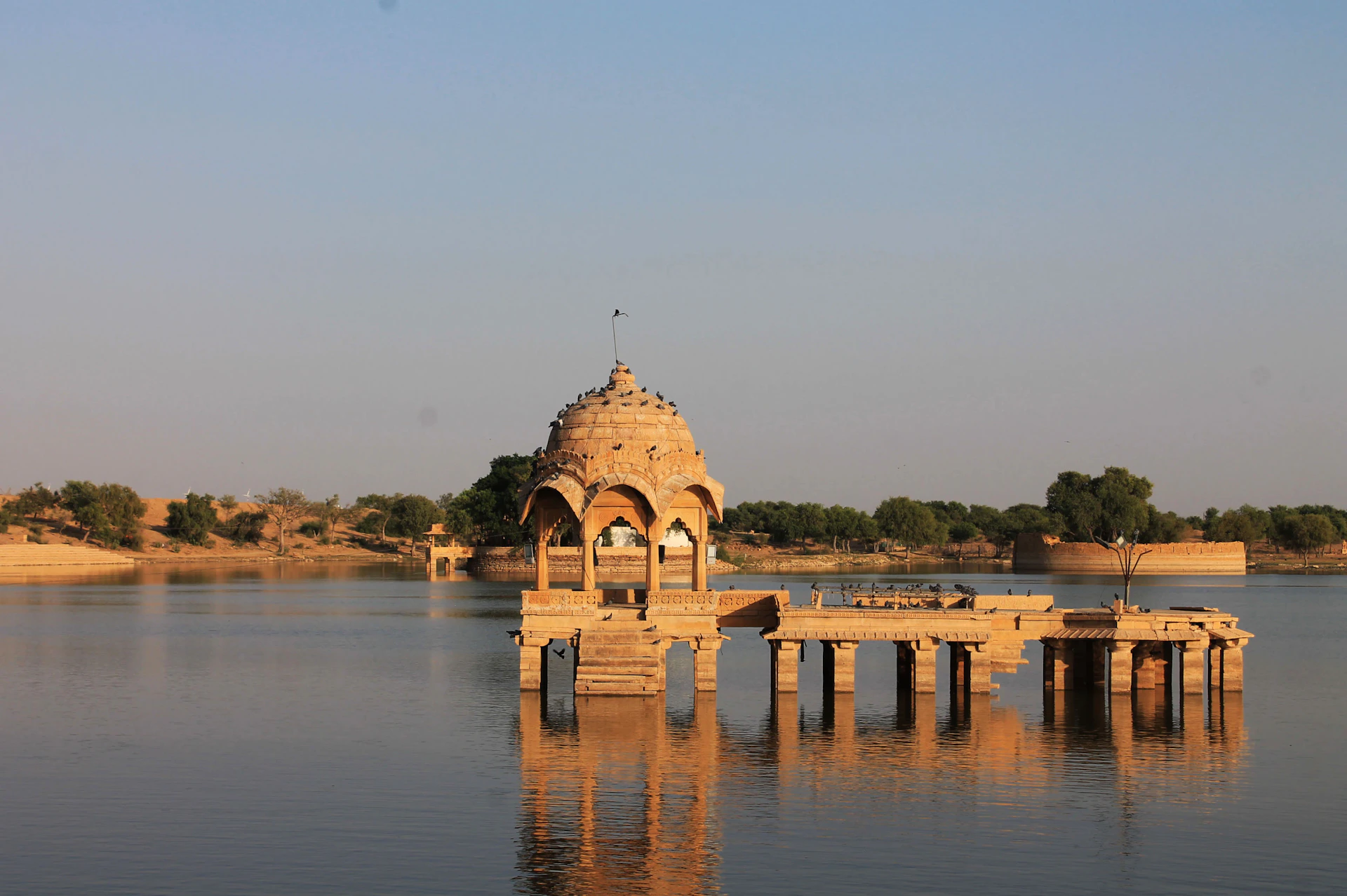 a large body of water with a building in the middle of it