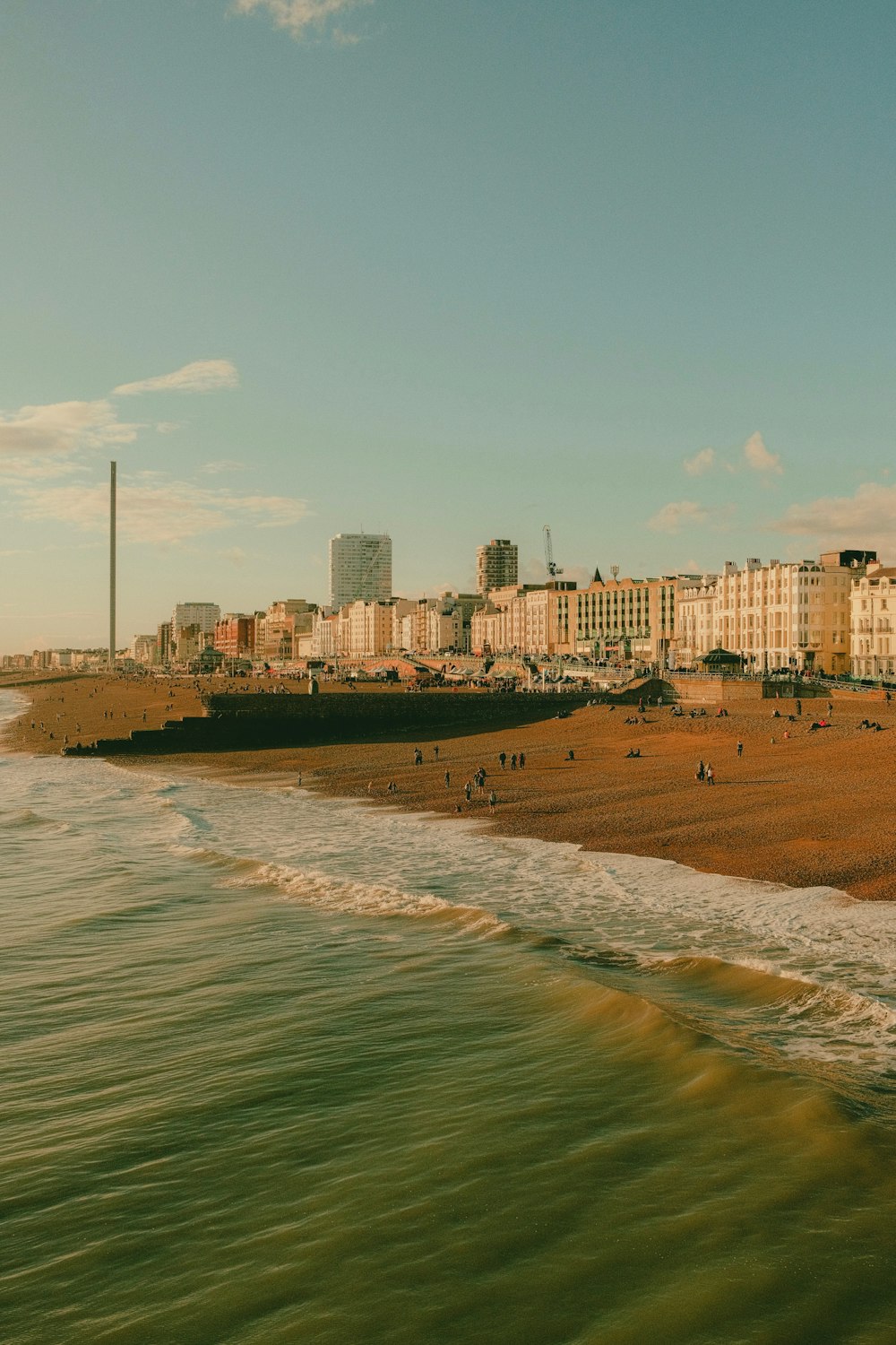 a view of a beach with buildings in the background