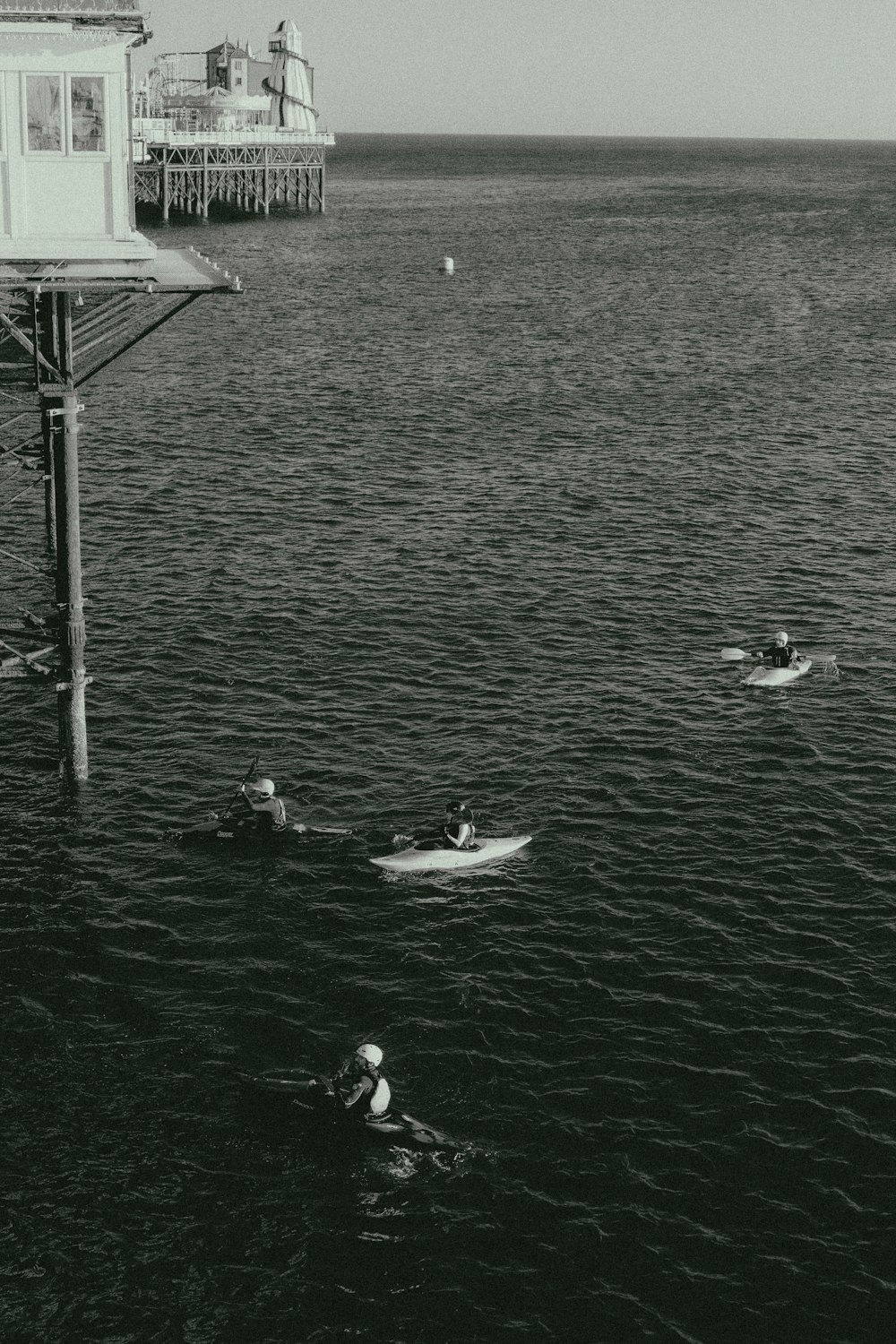 a black and white photo of people in the water